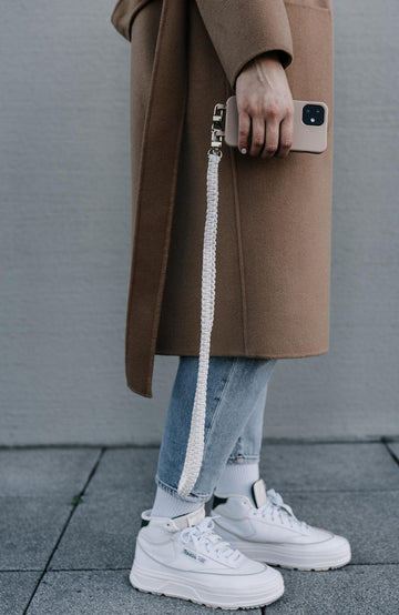 Frau mit Smart Case TAUPEGRAU & Boho Handyband NATURE in der Hand